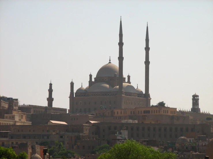 a mosque is seen from across the river