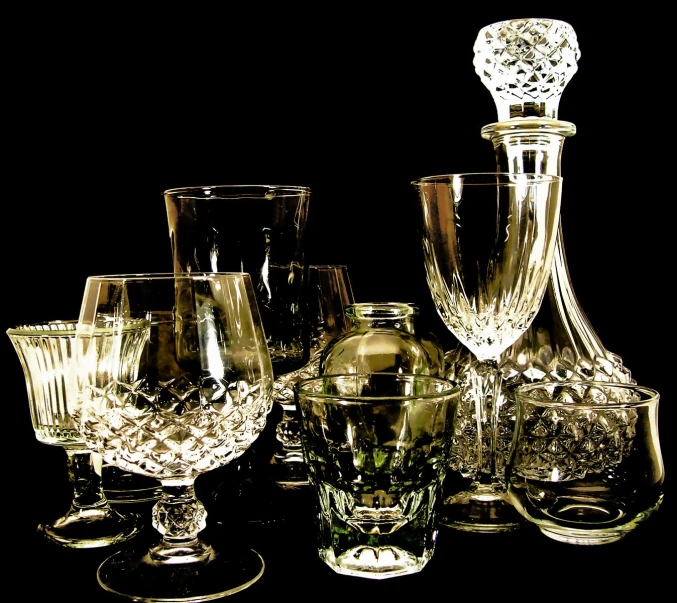 an assortment of wine glasses and a vase