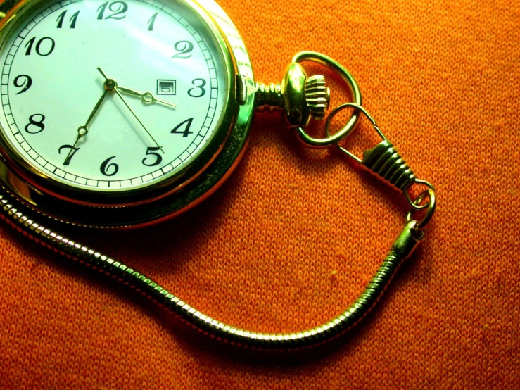 a pocket watch is sitting on a surface