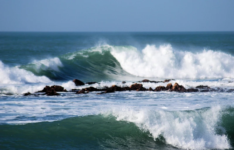 there are lots of white foamy waves coming in to shore