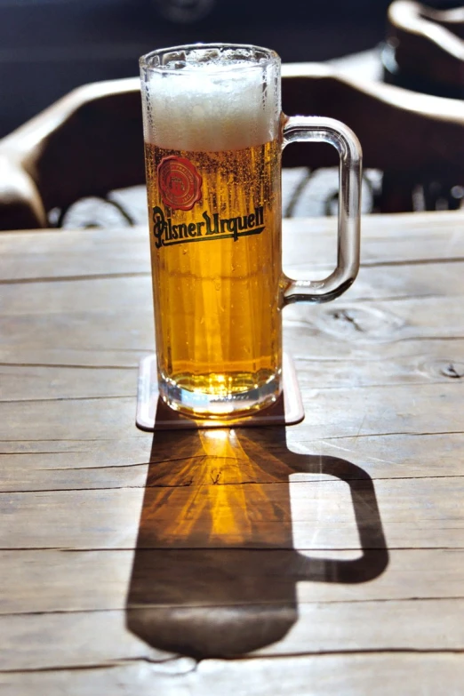 beer on a table in the shade of a bright window