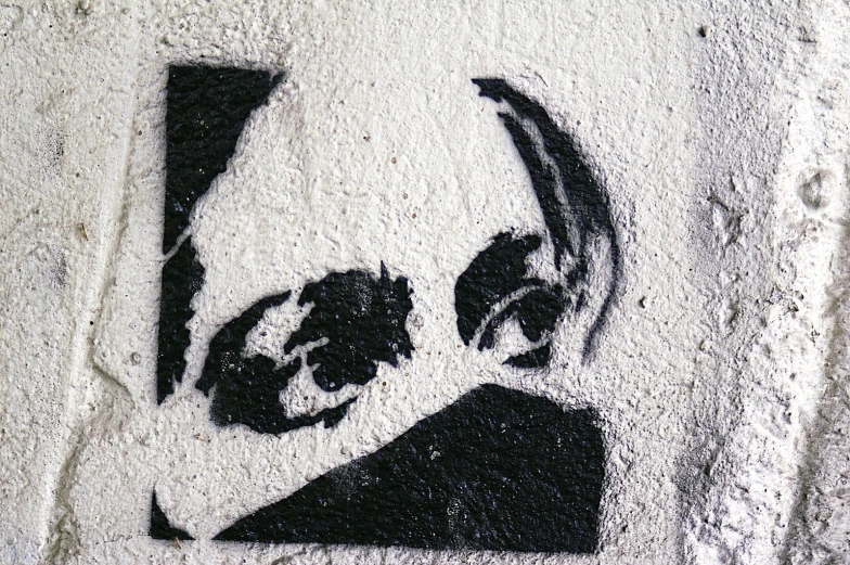 a graffiti image of a head with scissors