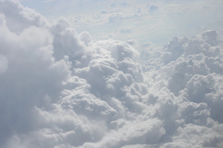 very many clouds are being seen through an airplane window