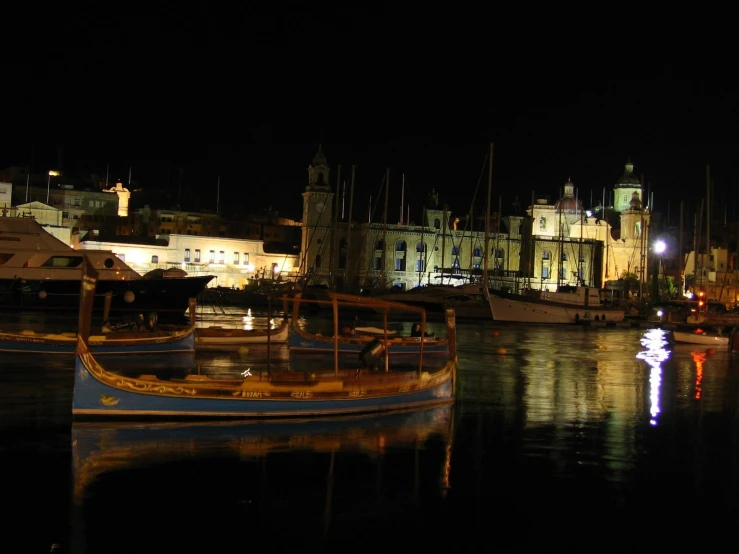 two boats are parked in the water near buildings