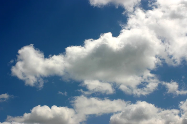 some clouds are flying in the blue sky