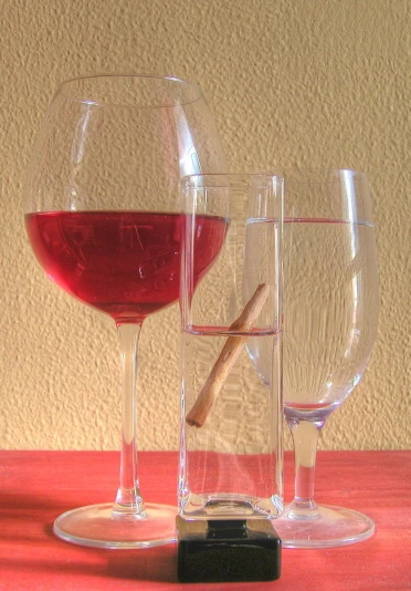a red wine glass sitting on top of a wooden table