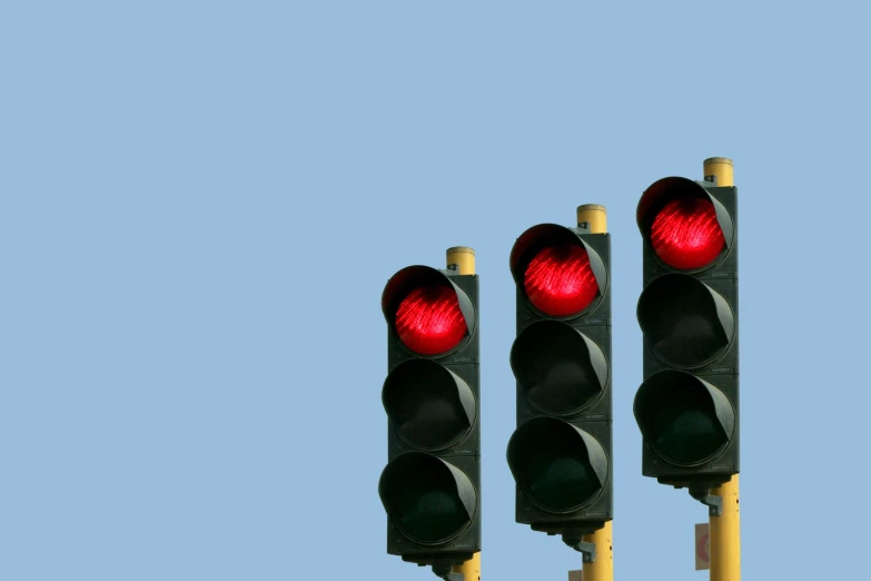 two traffic lights with one red lit up