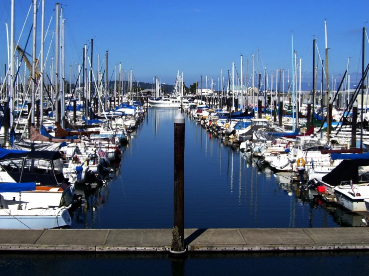 a marina filled with boats on top of a clear blue day