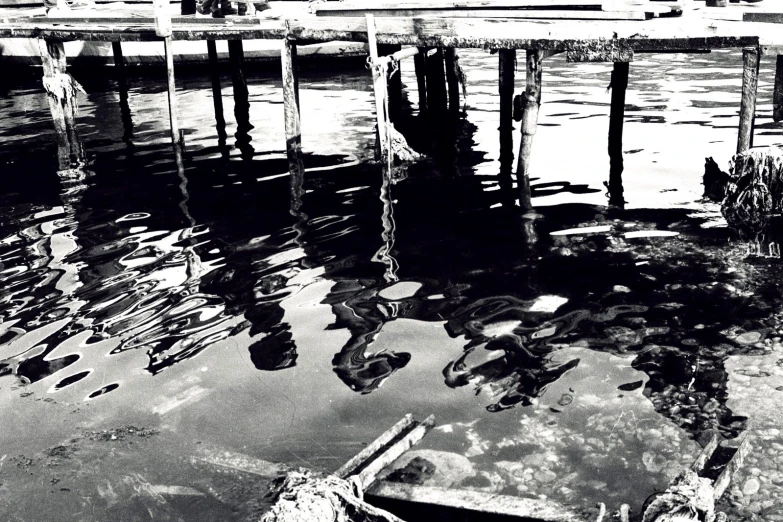 the reflection of a bridge in a body of water