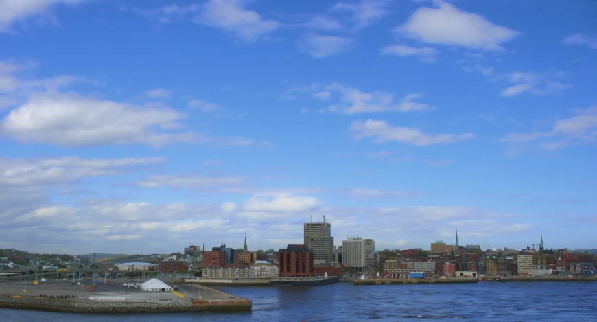 the view of some very tall buildings near the water