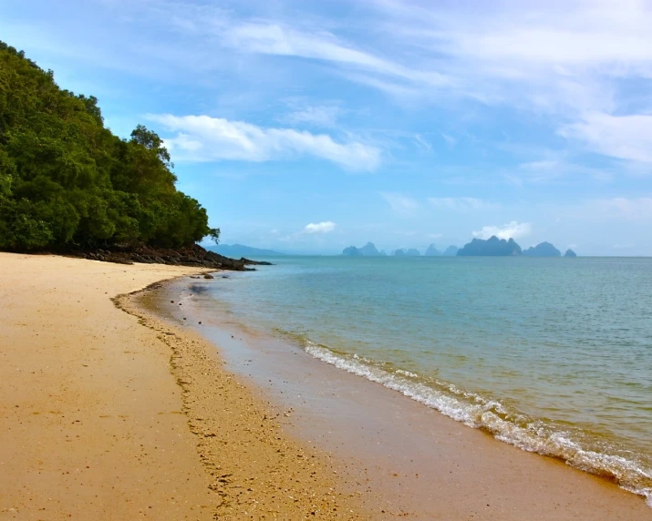 a beach area with waves crashing on it