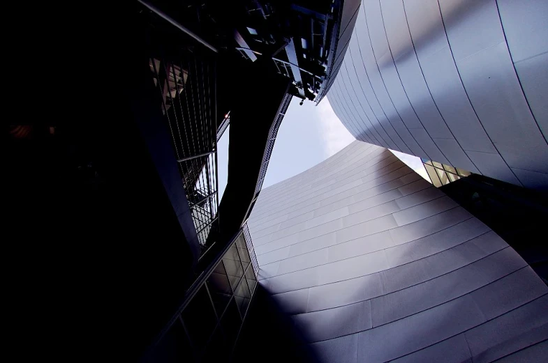 two tall structures in front of a very modern building