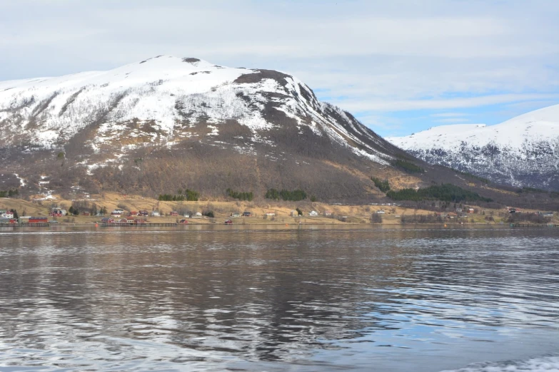 a body of water with a mountain in the background