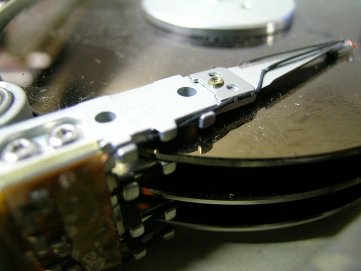 an old, dirty cd - rom drive with the disk being removed from its slot