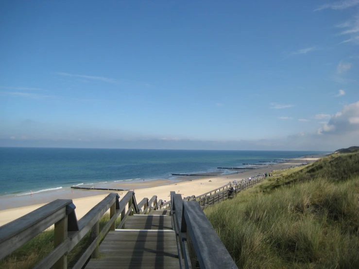 this boardwalk is on a beach that extends into the ocean