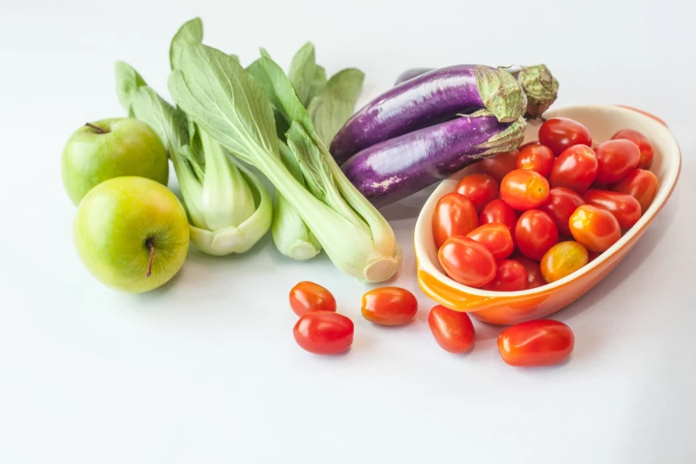 a white table filled with fruits and vegetables