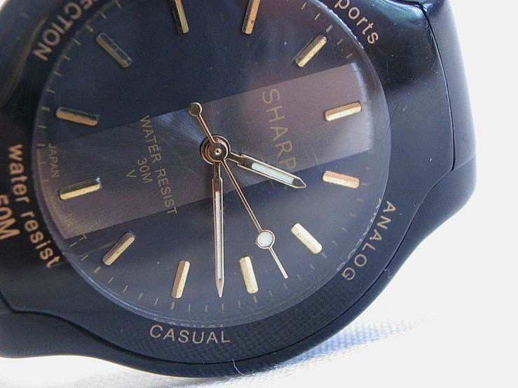 the large blue watch with gold details is on display