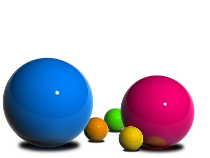 three colorful balls are sitting in a row