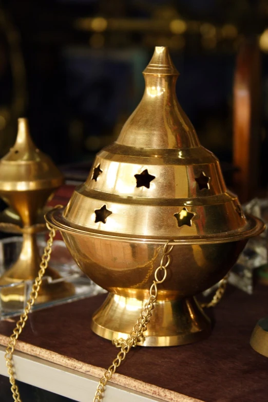 gold - plated jewelry is displayed with a star shaped container on a table