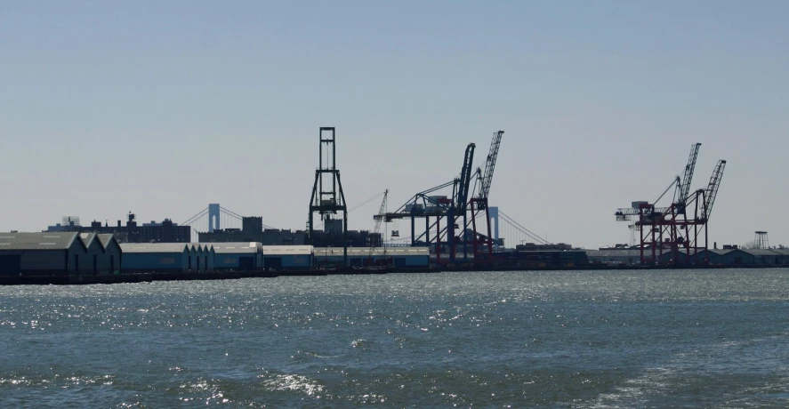 a body of water with lots of shipping cranes on it