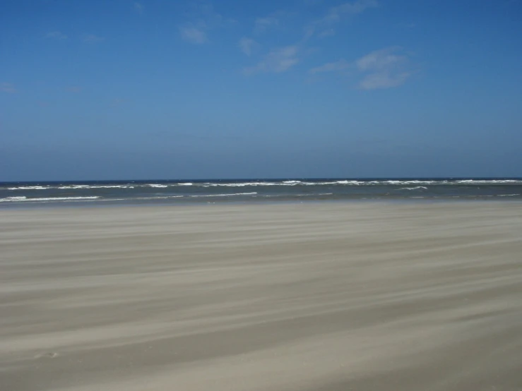 someone is on a large beach in the sun