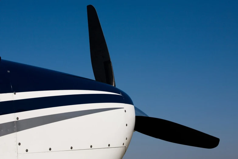 the wing of an airplane with black and white stripes