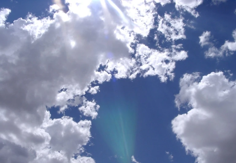 a very bright blue sky and some clouds