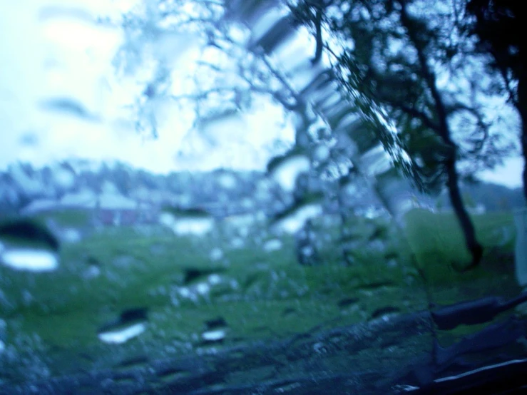 the window is covered in rain and water