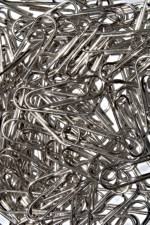 a pile of metal paper clips and rings