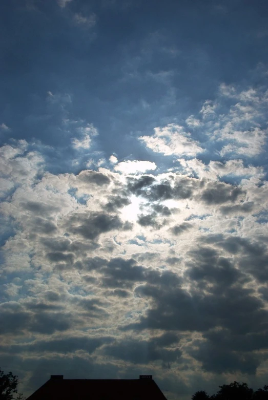 a church spire against a cloudy sky with clouds