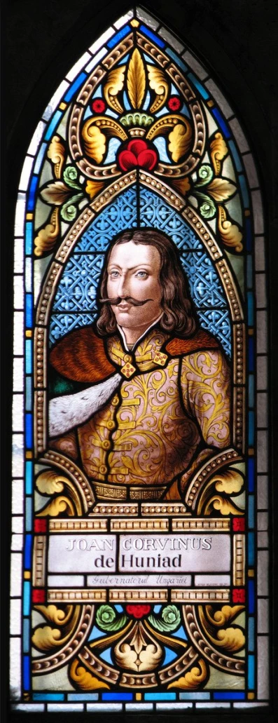 a stained glass window with a man holding a sword