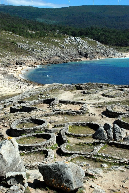 an area of stone next to a body of water