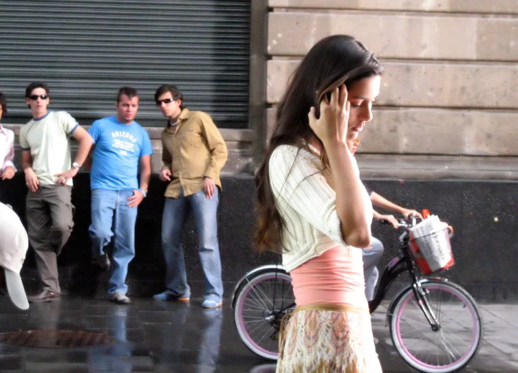 a woman in pink is walking on the sidewalk