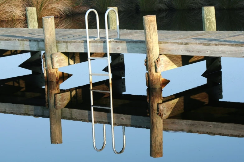 a boat dock with water and poles