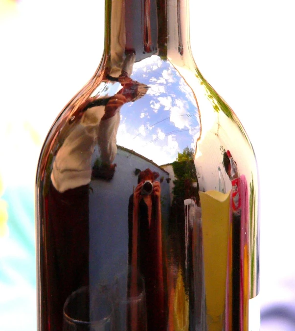 an image of reflection of a wine bottle