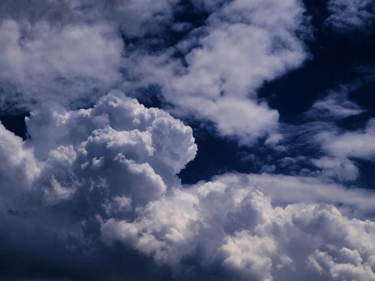 dark blue cloudy sky with an orange airplane in the center