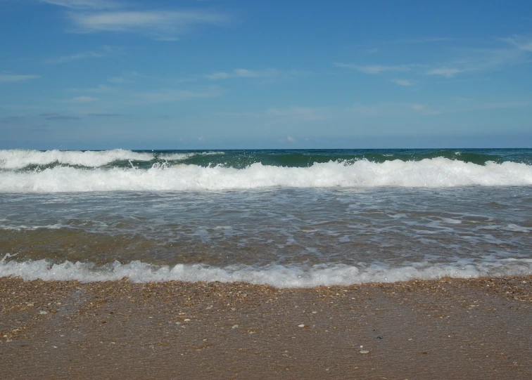 a po of a wave crashing onto the beach