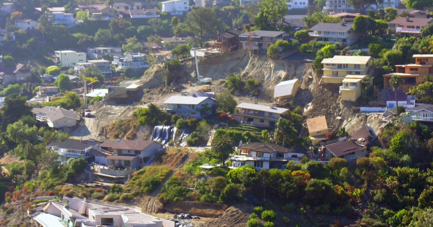 houses are perched on a hillside in front of the city