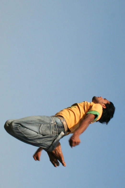 man in yellow shirt riding on a skateboard