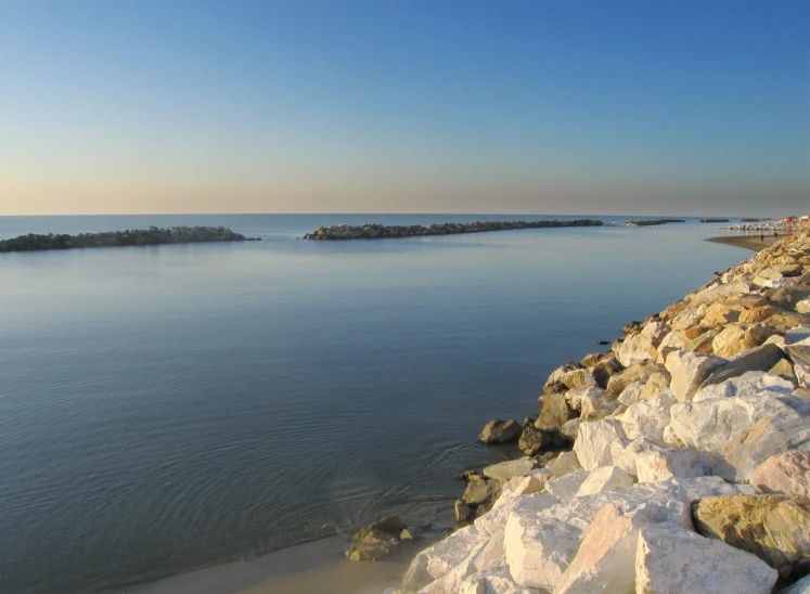 rocks and gravel along the shore at dusk