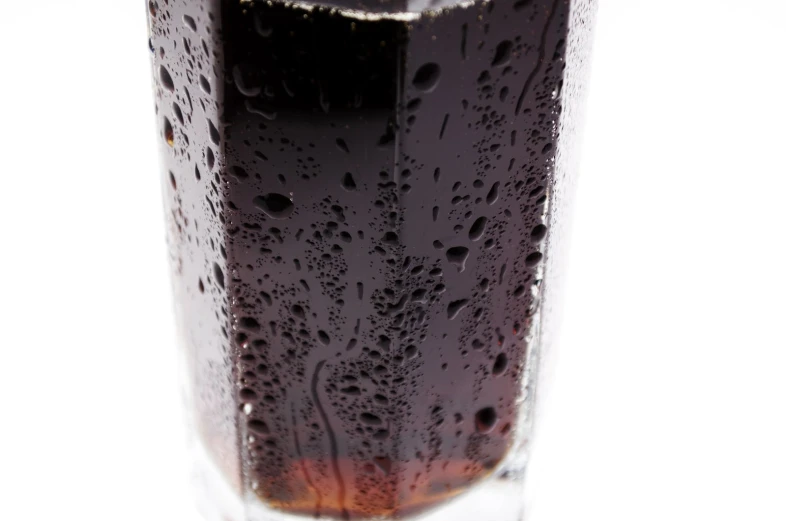 a glass with black liquid inside and water on top