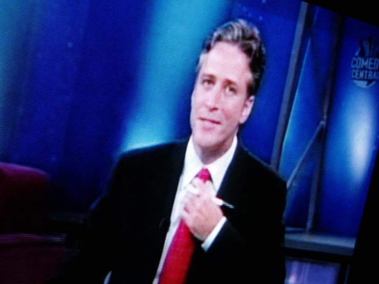 a television with a person in suit and tie on