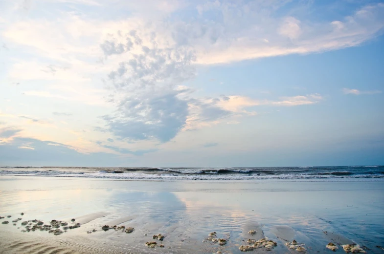 the beach has footprints in the sand and water