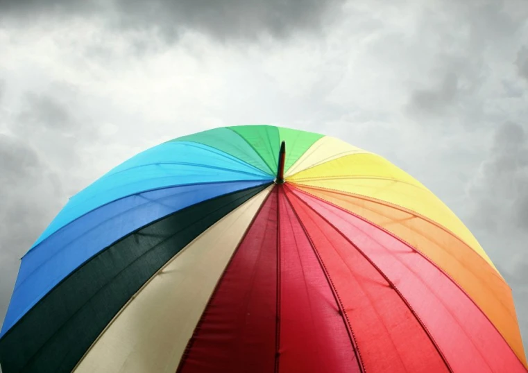 the rainbow umbrella is being held by a sky line