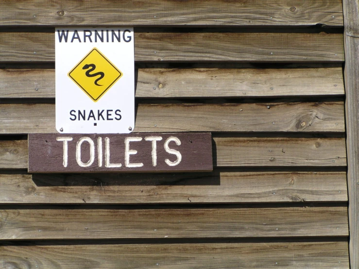 a wooden sign with white and yellow lettering on it