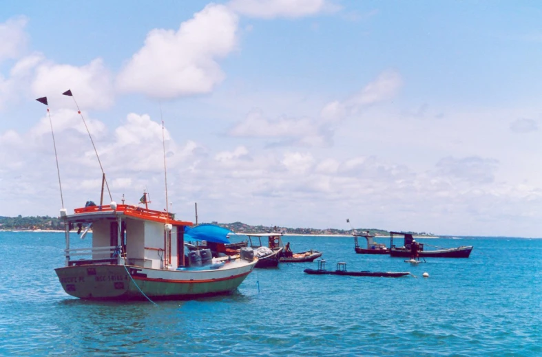 a boat is tied to a dock near another boat in the ocean