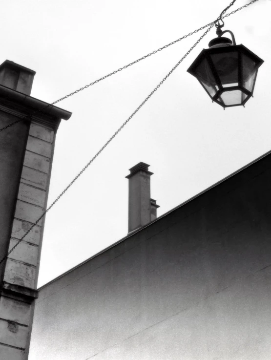 a light on a wire is hanging from a building