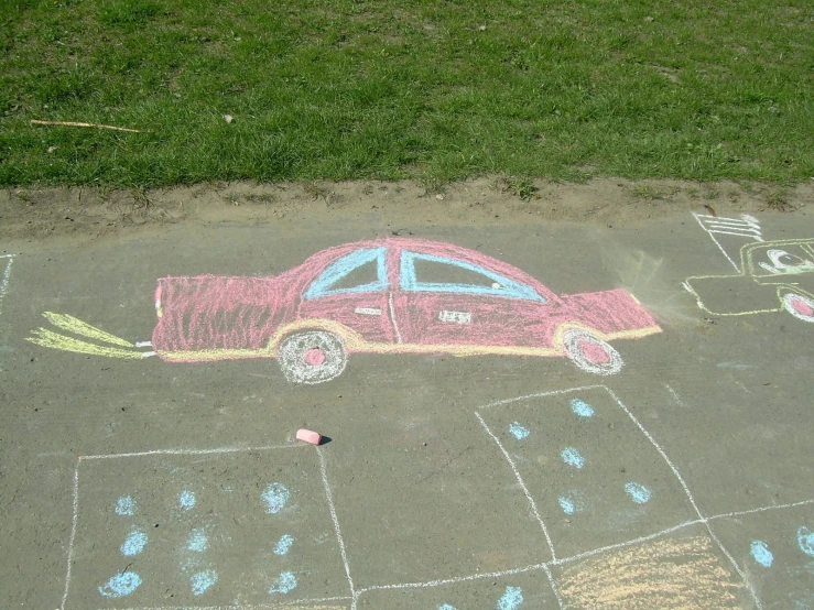 a child's drawing on the pavement is of a car