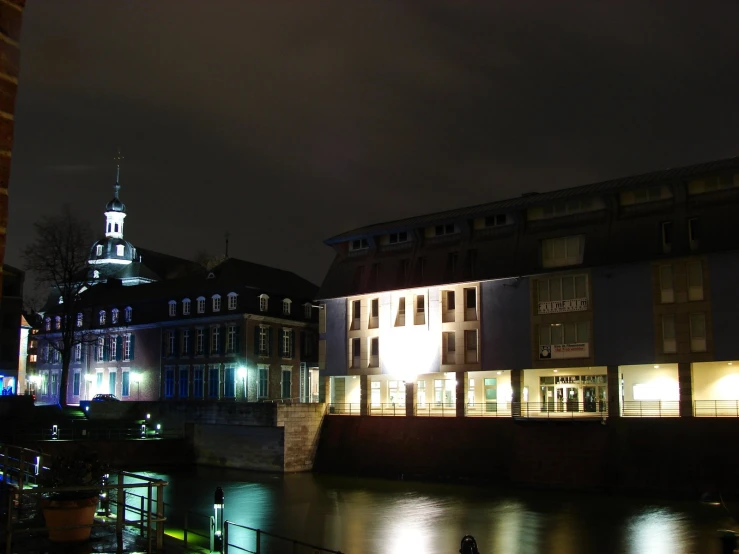 buildings in a city near the water at night