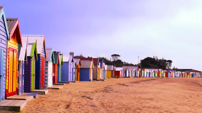 the colorful beach huts are near the ocean